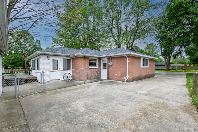 2548 Hearthside Dr, Ypsilanti, MI 48198 - view of front of house featuring brick siding, a gate, a chimney, and concrete driveway