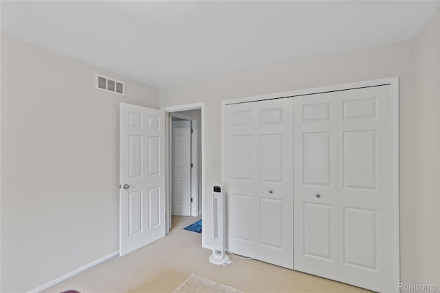 2375 Mulberry Sq Unit 69, Bloomfield Hills, MI 48302 - unfurnished bedroom with light colored carpet, a closet, and baseboards