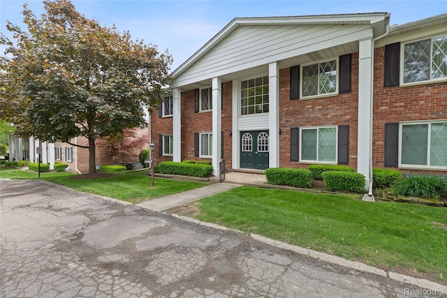 2375 Mulberry Sq Unit 69, Bloomfield Hills, MI 48302 - greek revival house featuring brick siding and a front yard