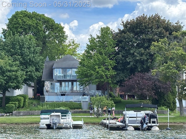 2222 Garland St, Sylvan Lake, MI 48320 - view of front of house featuring a water view, a dock, stone siding, and a balcony
