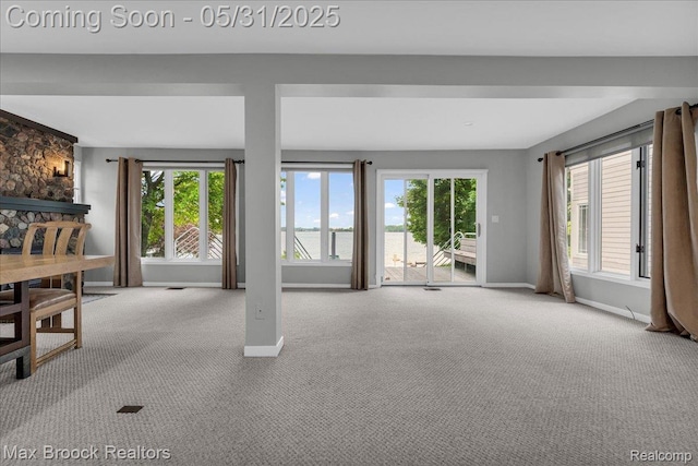 2222 Garland St, Sylvan Lake, MI 48320 - unfurnished living room featuring carpet, healthy amount of natural light, and baseboards