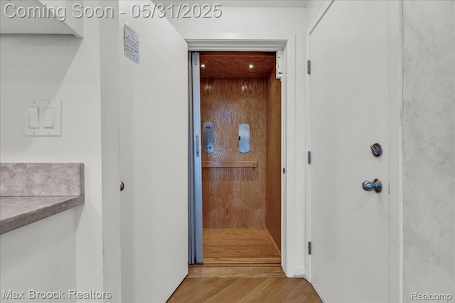2222 Garland St, Sylvan Lake, MI 48320 - hallway featuring wood finished floors and elevator
