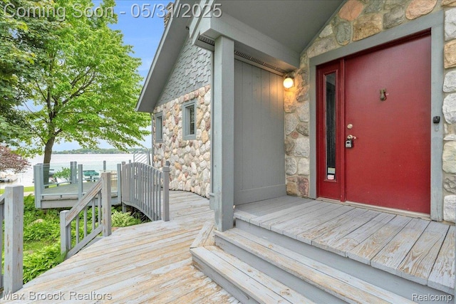 2222 Garland St, Sylvan Lake, MI 48320 - view of exterior entry with stone siding and a water view