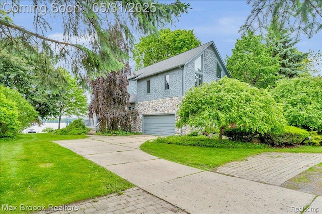 2222 Garland St, Sylvan Lake, MI 48320 - view of side of home with stone siding, driveway, a garage, and a lawn