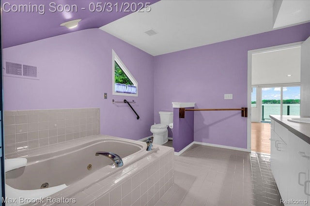 2222 Garland St, Sylvan Lake, MI 48320 - bathroom with vanity, toilet, a whirlpool tub, lofted ceiling, and baseboards