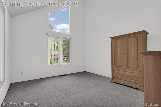 2222 Garland St, Sylvan Lake, MI 48320 - unfurnished bedroom with a towering ceiling and carpet