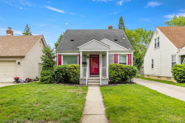 3135 Raymond Ave, Dearborn, MI 48124 - view of front of home featuring a front yard, a shingled roof, and a chimney