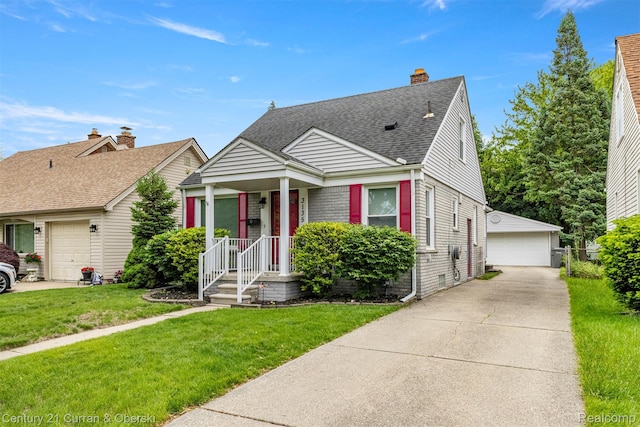 3135 Raymond Ave, Dearborn, MI 48124 - bungalow with a detached garage, roof with shingles, an outbuilding, a front lawn, and brick siding