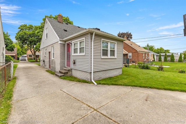 3135 Raymond Ave, Dearborn, MI 48124 - view of home's exterior featuring a chimney, a shingled roof, and entry steps