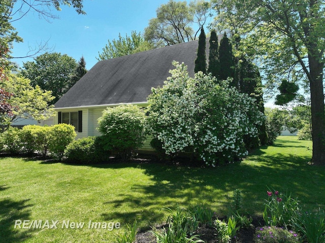 5475 George St, Saginaw, MI 48603 - view of side of property with a lawn and a shingled roof