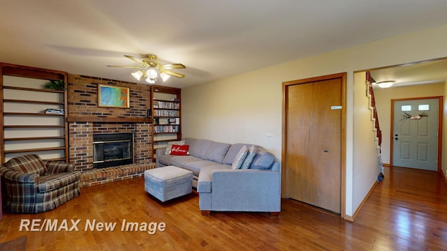 5475 George St, Saginaw, MI 48603 - living room with wood finished floors, a ceiling fan, and a fireplace