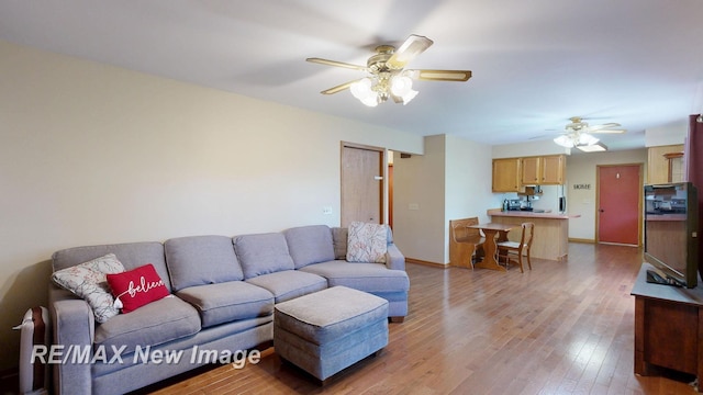 5475 George St, Saginaw, MI 48603 - living room featuring ceiling fan, light wood finished floors, and baseboards