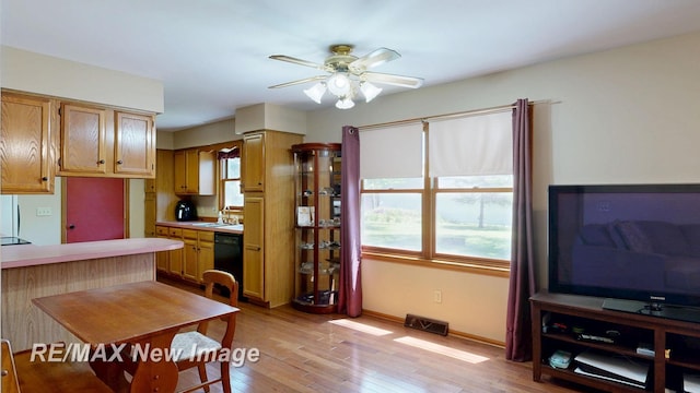 5475 George St, Saginaw, MI 48603 - dining area featuring a ceiling fan, light wood finished floors, and baseboards