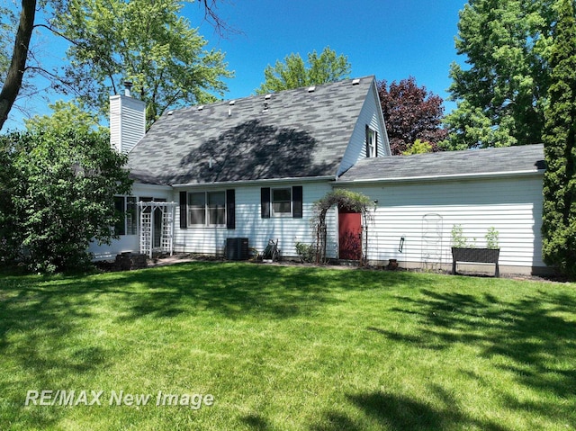 5475 George St, Saginaw, MI 48603 - view of front of property featuring a chimney, a front lawn, central AC, and a shingled roof