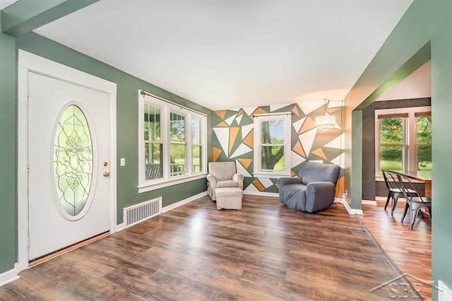 1784 S Badour Rd, Midland, MI 48640 - entrance foyer featuring wood finished floors, baseboards, and an accent wall