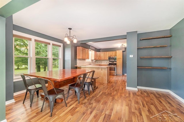 1784 S Badour Rd, Midland, MI 48640 - dining space with a chandelier, light wood-type flooring, and baseboards