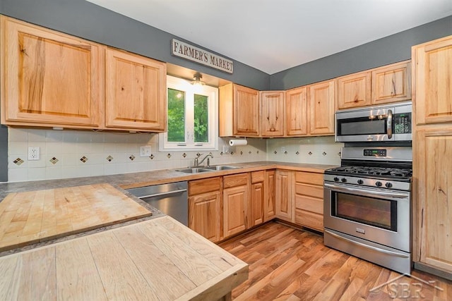 1784 S Badour Rd, Midland, MI 48640 - kitchen with appliances with stainless steel finishes, a sink, light brown cabinetry, and light wood-style floors
