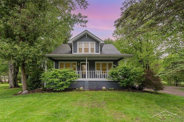 1784 S Badour Rd, Midland, MI 48640 - bungalow-style home featuring covered porch and a front lawn