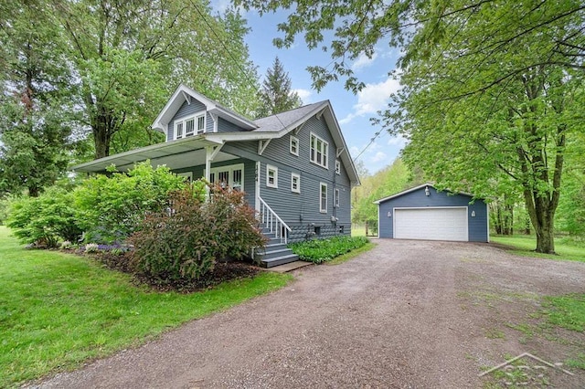 1784 S Badour Rd, Midland, MI 48640 - view of front facade featuring an outbuilding, a detached garage, and a front lawn