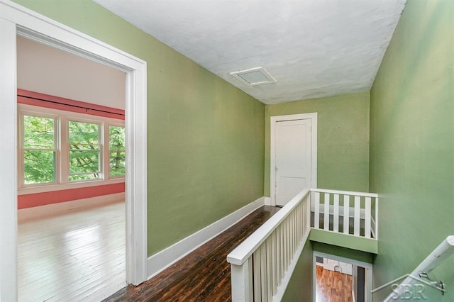 1784 S Badour Rd, Midland, MI 48640 - hall with baseboards, wood finished floors, an upstairs landing, and attic access
