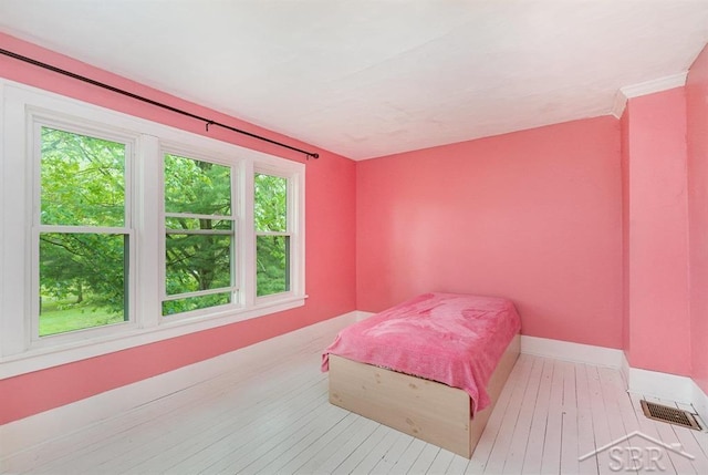 1784 S Badour Rd, Midland, MI 48640 - bedroom with baseboards and wood-type flooring