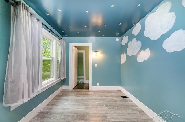 1784 S Badour Rd, Midland, MI 48640 - unfurnished room featuring wood finished floors, baseboards, and recessed lighting
