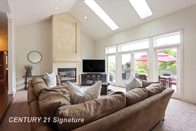 2170 Chestnut Rdg, Saginaw, MI 48609 - carpeted living room with a skylight, high vaulted ceiling, a tile fireplace, baseboards, and recessed lighting