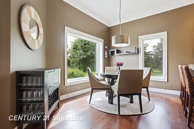 2170 Chestnut Rdg, Saginaw, MI 48609 - dining space featuring healthy amount of natural light, ornamental molding, baseboards, and wood finished floors