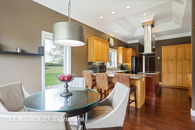 2170 Chestnut Rdg, Saginaw, MI 48609 - dining space with ornamental molding, dark wood-type flooring, a raised ceiling, decorative columns, and recessed lighting