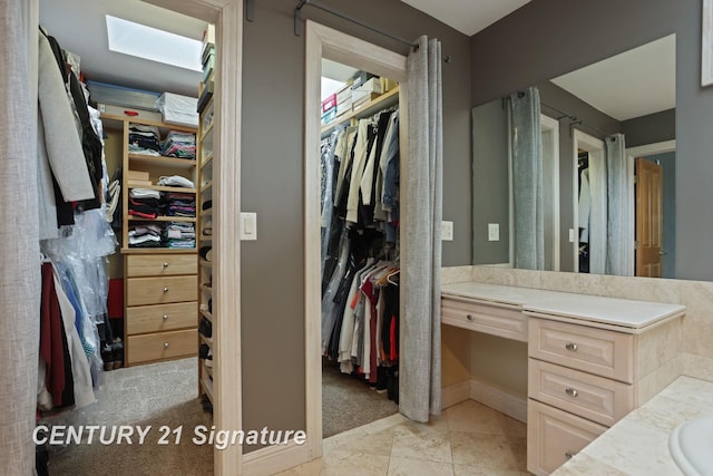 2170 Chestnut Rdg, Saginaw, MI 48609 - full bath with vanity, a walk in closet, a skylight, and baseboards