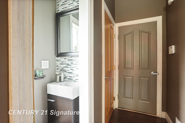 2170 Chestnut Rdg, Saginaw, MI 48609 - bathroom featuring backsplash, vanity, and wood finished floors
