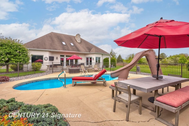 2170 Chestnut Rdg, Saginaw, MI 48609 - view of swimming pool featuring a water slide, a patio, and outdoor dining space