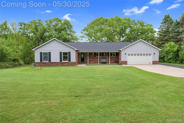 9587 Harmon Ln, South Lyon, MI 48178 - view of front of home with a porch, a garage, a front yard, driveway, and brick siding