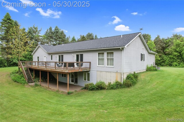 9587 Harmon Ln, South Lyon, MI 48178 - back of house with a wooden deck, a lawn, stairs, a shingled roof, and a patio