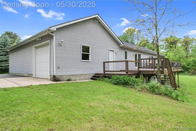 9587 Harmon Ln, South Lyon, MI 48178 - view of property exterior featuring a deck, a lawn, stairway, a garage, and driveway