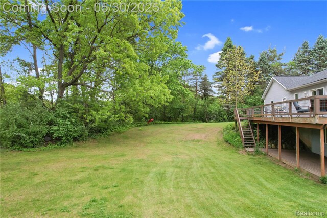 9587 Harmon Ln, South Lyon, MI 48178 - view of green lawn featuring a deck and stairs