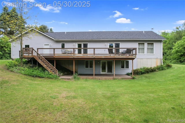 9587 Harmon Ln, South Lyon, MI 48178 - back of property featuring a deck, a lawn, roof with shingles, and a patio