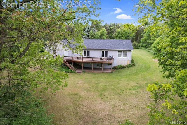 9587 Harmon Ln, South Lyon, MI 48178 - back of property featuring a deck, a lawn, stairs, and roof with shingles