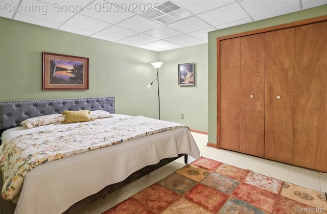9587 Harmon Ln, South Lyon, MI 48178 - bedroom with a drop ceiling, a closet, and light tile patterned floors