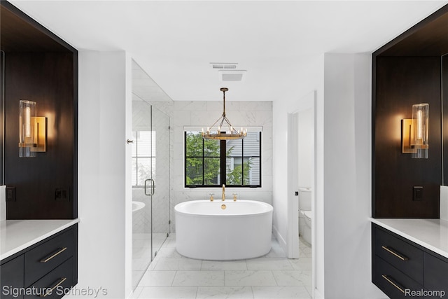 608 Stanley Blvd, Birmingham, MI 48009 - full bath with marble look tiles, vanity, a freestanding tub, toilet, and a shower stall