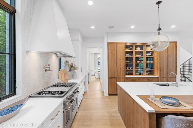 608 Stanley Blvd, Birmingham, MI 48009 - kitchen featuring custom exhaust hood, a sink, light wood finished floors, decorative backsplash, and recessed lighting