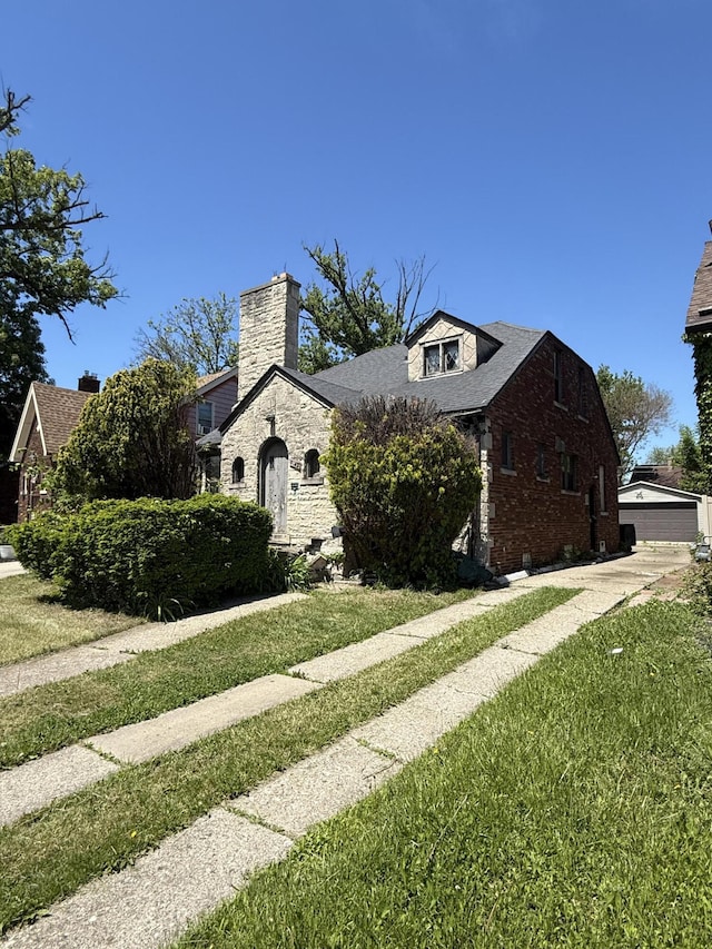 9142 Yorkshire Rd, Detroit, MI 48224 - view of front of house with a front lawn, brick siding, and a chimney