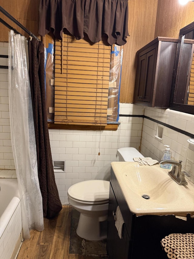 9142 Yorkshire Rd, Detroit, MI 48224 - bathroom featuring tile walls, wood finished floors, toilet, vanity, and shower / bathtub combination with curtain