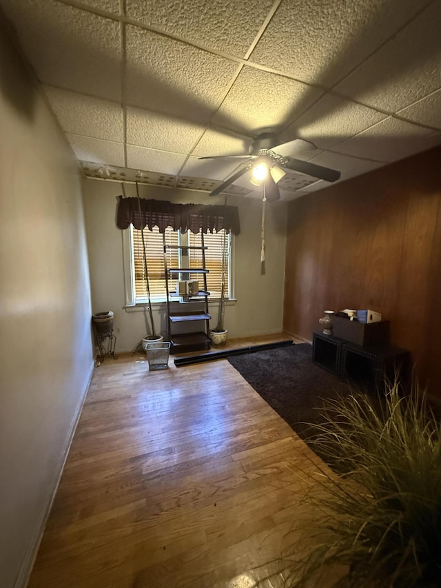 9142 Yorkshire Rd, Detroit, MI 48224 - spare room featuring wood finished floors, a paneled ceiling, a ceiling fan, and baseboards