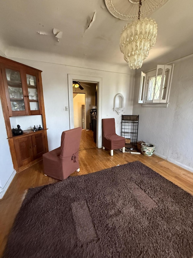 9142 Yorkshire Rd, Detroit, MI 48224 - sitting room with wood finished floors, a chandelier, a ceiling fan, and baseboards