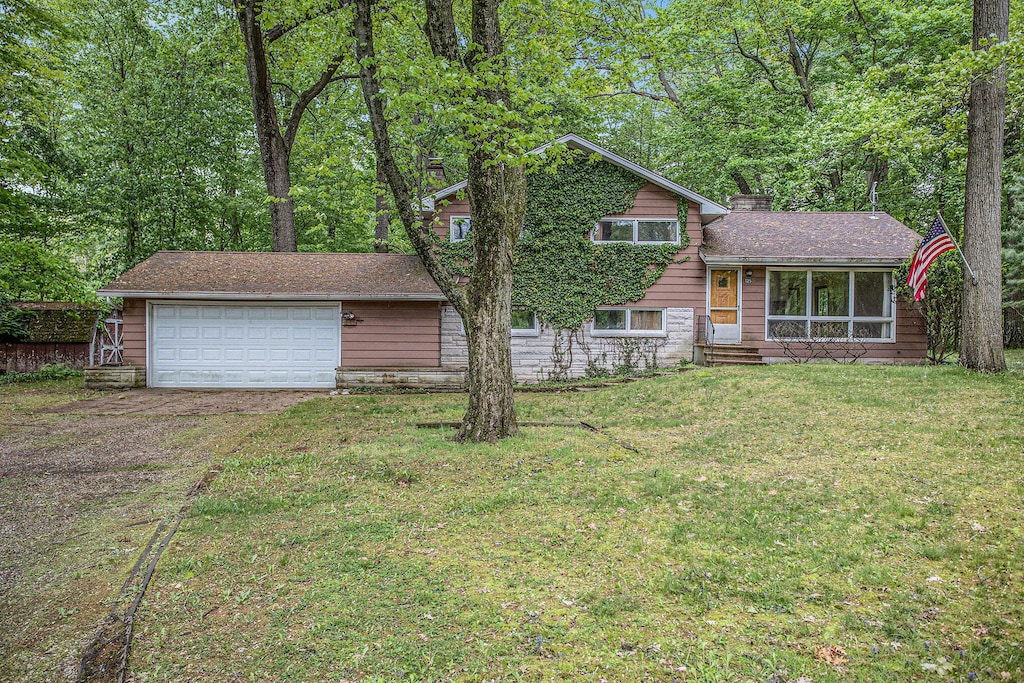 125 Christy Rd, Battle Creek, MI 49015 - tri-level home featuring driveway, a front yard, and a chimney