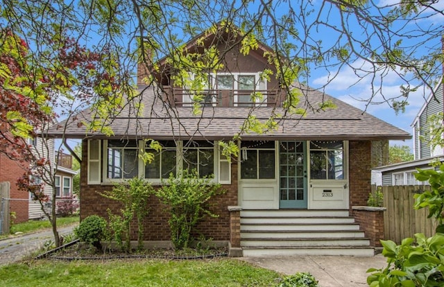 2313 S Westnedge Ave, Kalamazoo, MI 49008 - bungalow with brick siding, roof with shingles, and a chimney
