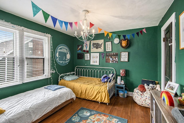 2313 S Westnedge Ave, Kalamazoo, MI 49008 - bedroom with a chandelier, hardwood / wood-style floors, and baseboards