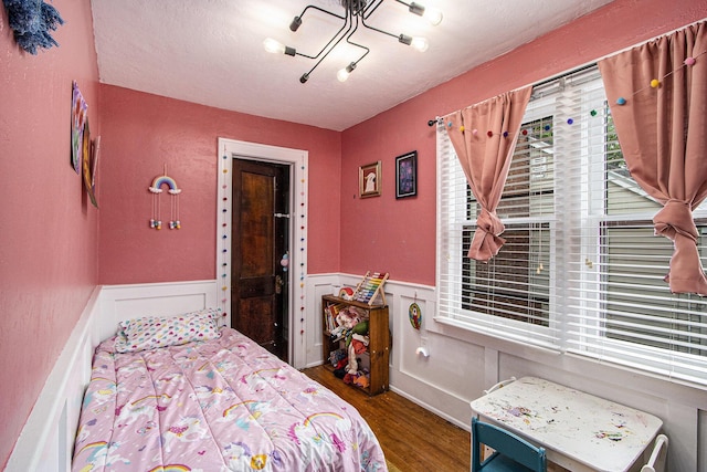 2313 S Westnedge Ave, Kalamazoo, MI 49008 - bedroom featuring wood finished floors and a wainscoted wall