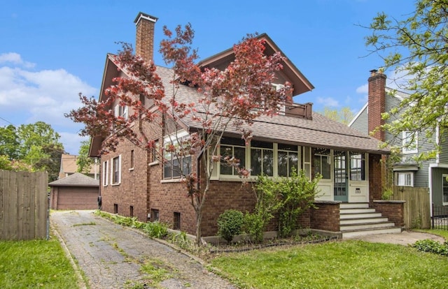 2313 S Westnedge Ave, Kalamazoo, MI 49008 - view of front of house with a chimney, brick siding, a garage, and roof with shingles